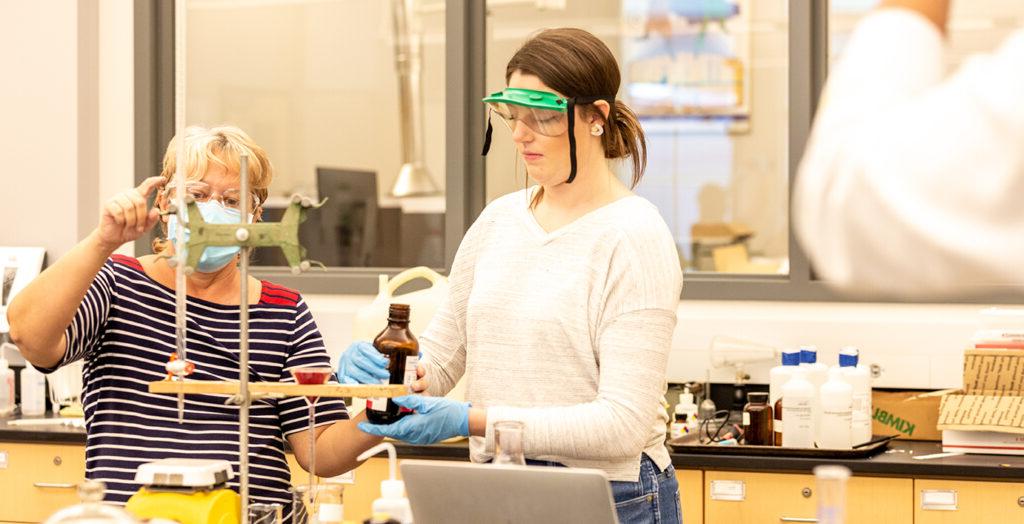 faculty member assisting student researcher in laboratory experiment